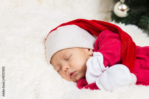 cute baby sleeping in Christmas clothes