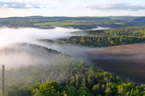 Canyon river Elbe with morning fog from sandstone tower Zirkelstein in Saxon Switzerland, Germany.