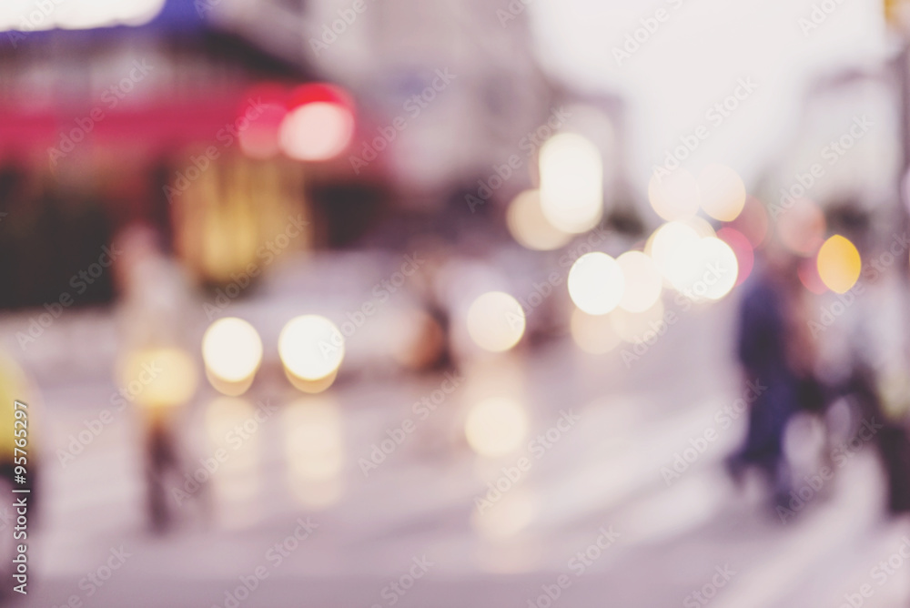 people walking on street in urban city, defocused image, city scene