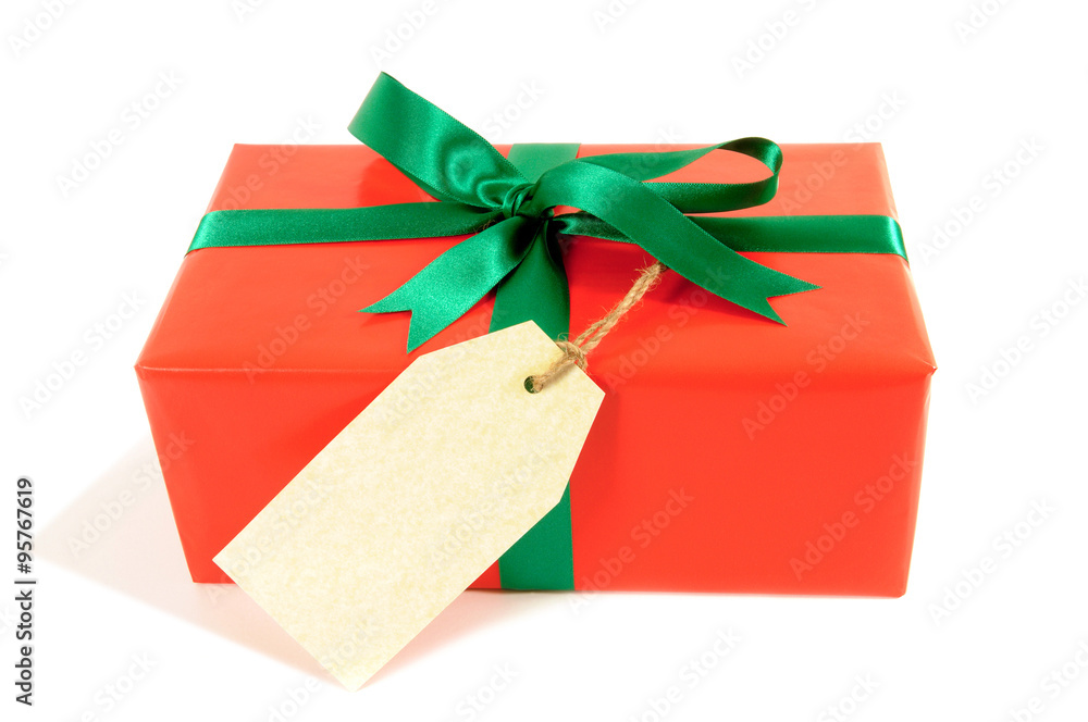 One single small wrapped red christmas present or birthday gift with plain gift tag isolated on white background photo One single small wrapped red christmas present or birthday gift with plain gift tag isolated on white background photo