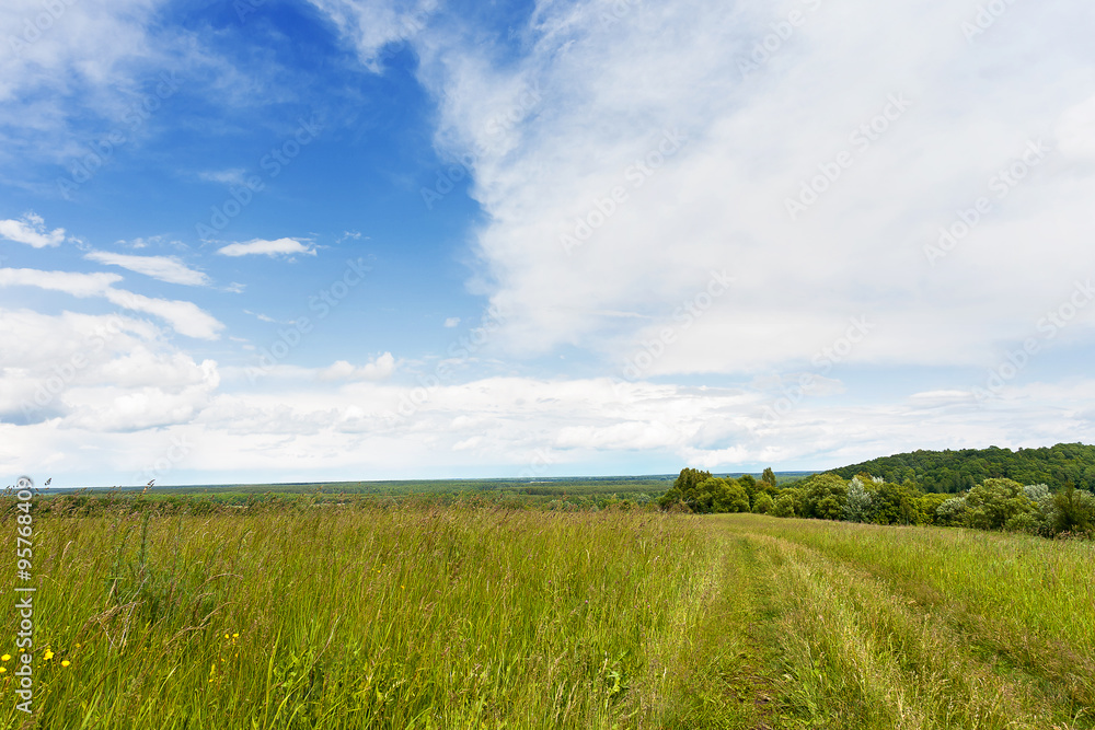 Abstract natural background. Rural path winds along the field. Russia. Abstract natural background. Rural path winds along the field. Russia.