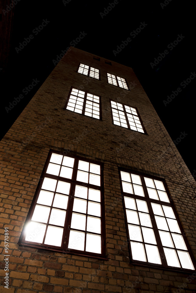 tall building with brick walls and big windows
