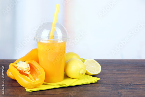 Fresh vegetable juice on wooden table,on bright background