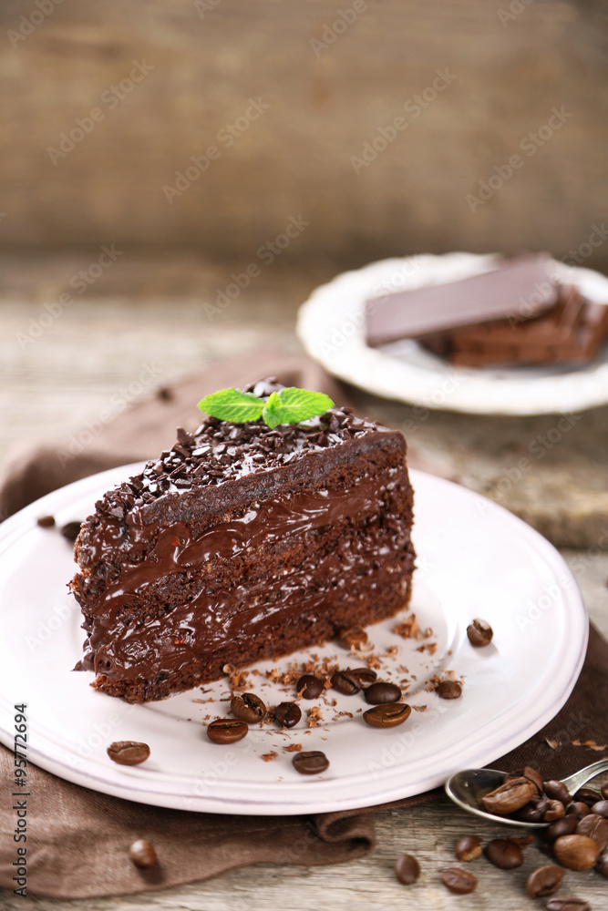 Chocolate cake with chocolate cream and fresh berries on plate, on wooden background Chocolate cake with chocolate cream and fresh berries on plate, on wooden background
