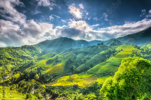 Sun star above the beautiful highland Sapa with its rays to the valley with terraces around the hill look impressive