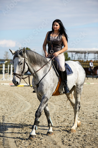 Woman astride a horse