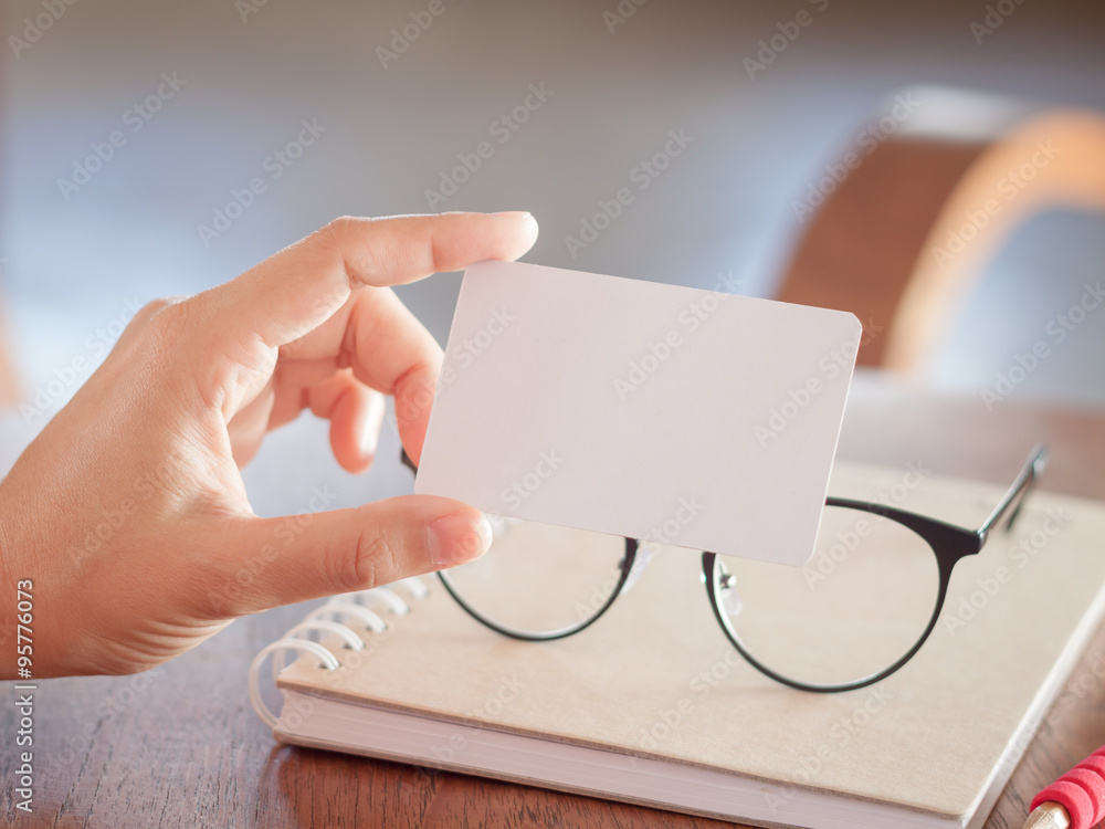 Woman hold blank business cards Woman hold blank business cards