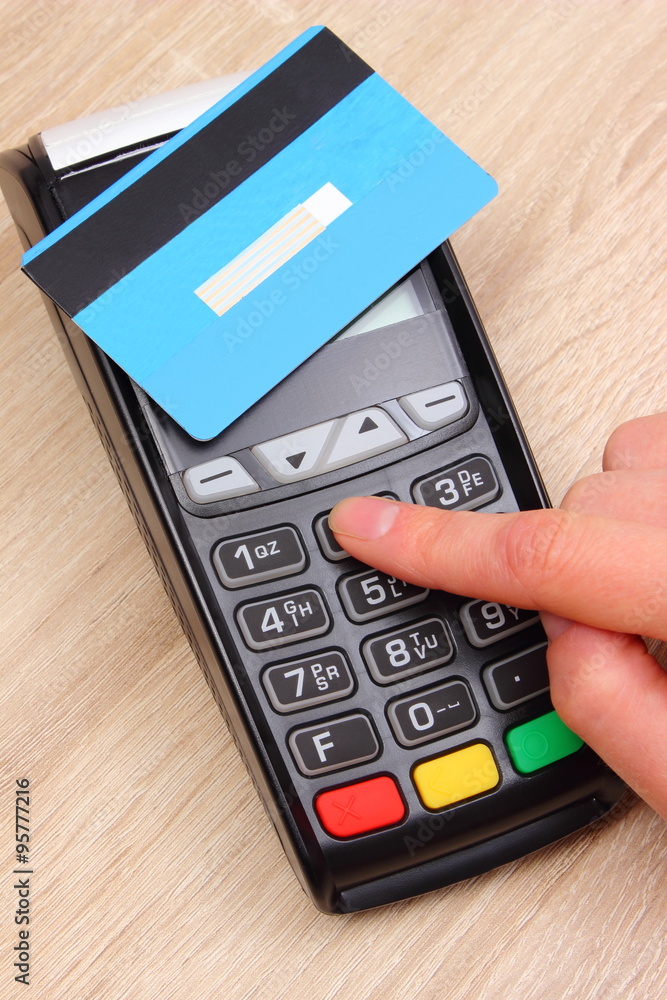 Hand of woman using payment terminal, enter personal identification number Hand of woman using payment terminal, enter personal identification number