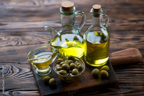 Glass bottles with extra virgin olive oil, selective focus