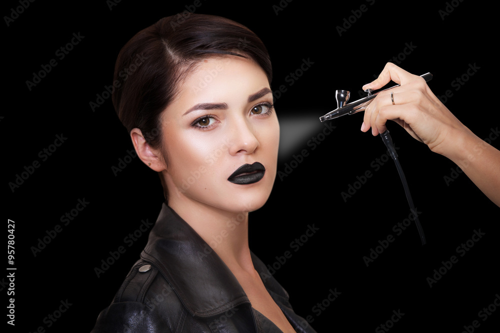 Obraz premium close portrait of a beautiful girl with make-up . Make up with airbrush. Isolated on black background. Copy space..