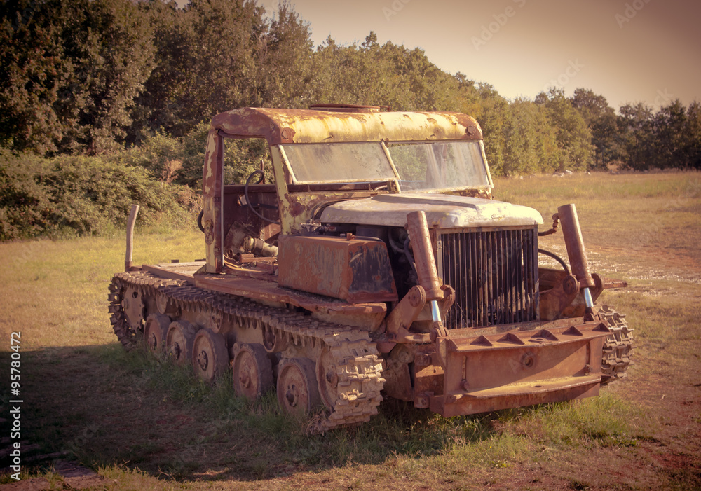 Crawler tractor. Retro toned photo.