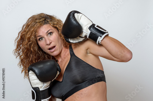 young woman wearing boxing gloves © michaelheim