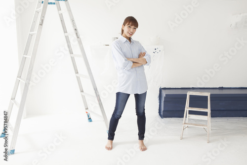 Young women are painting a room