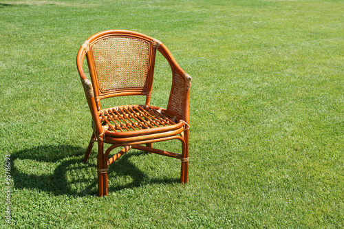 wicker chair on the background of fresh grass