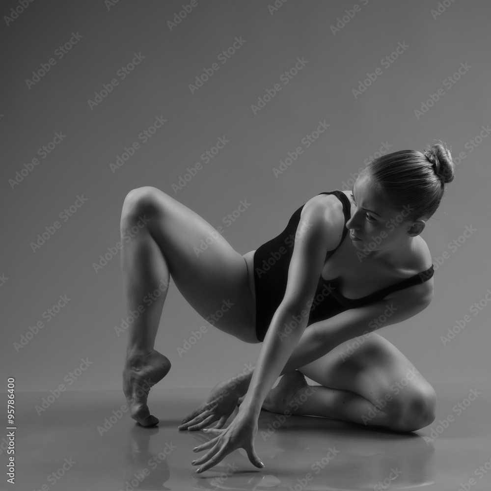 Naklejka premium Modern ballet dancer posing on dark background