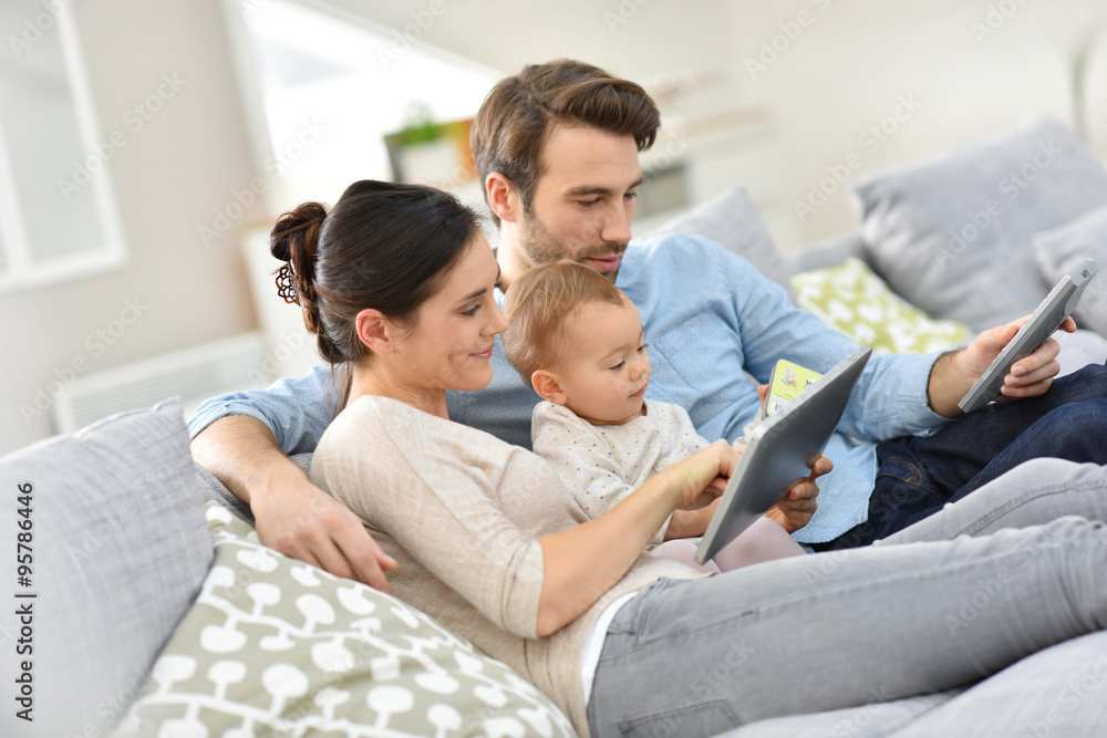 Family with baby in sofa watching tv Family with baby in sofa watching tv