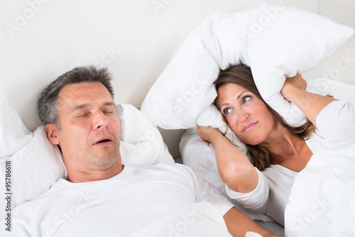 Angry Woman Trying To Sleep With Snoring Man