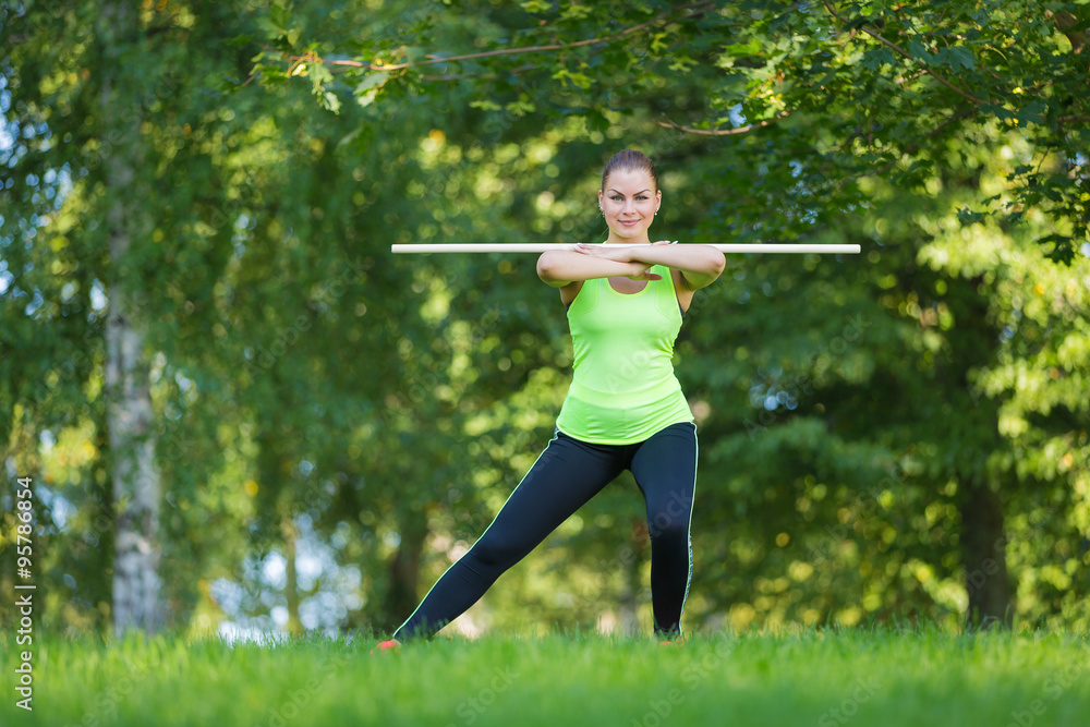 Fit woman exercising in park