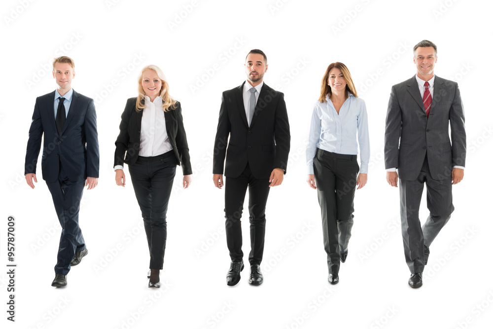 Confident Business People Walking Against White Background Confident Business People Walking Against White Background