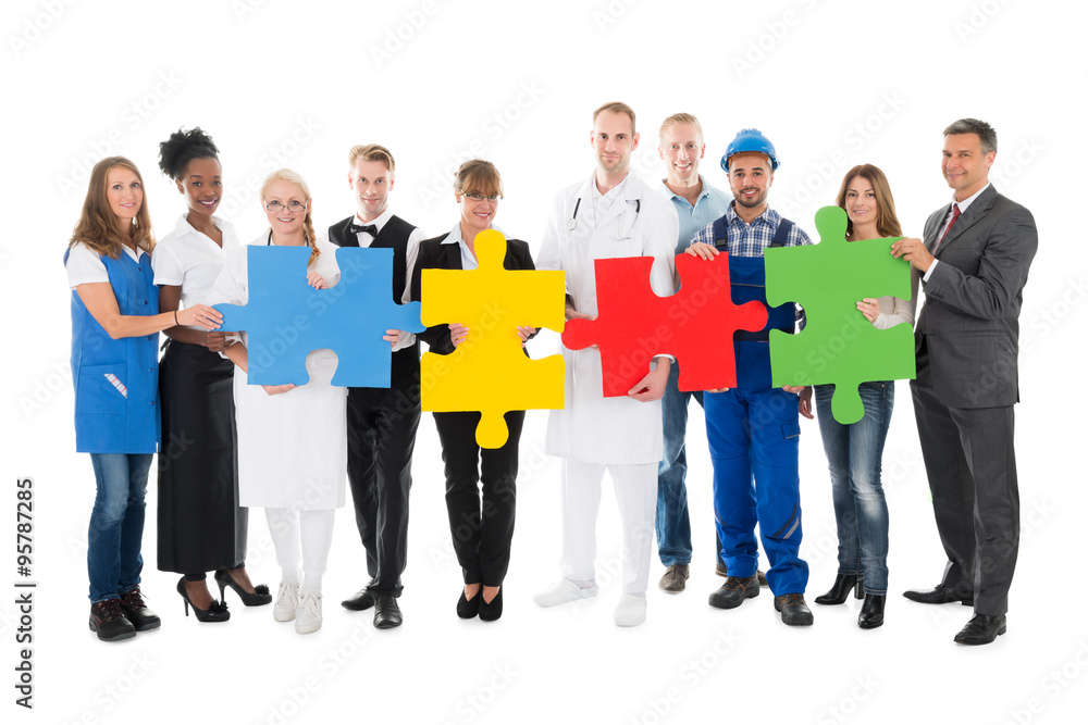Fototapeta premium Confident People With Various Occupations Holding Jigsaw Pieces
