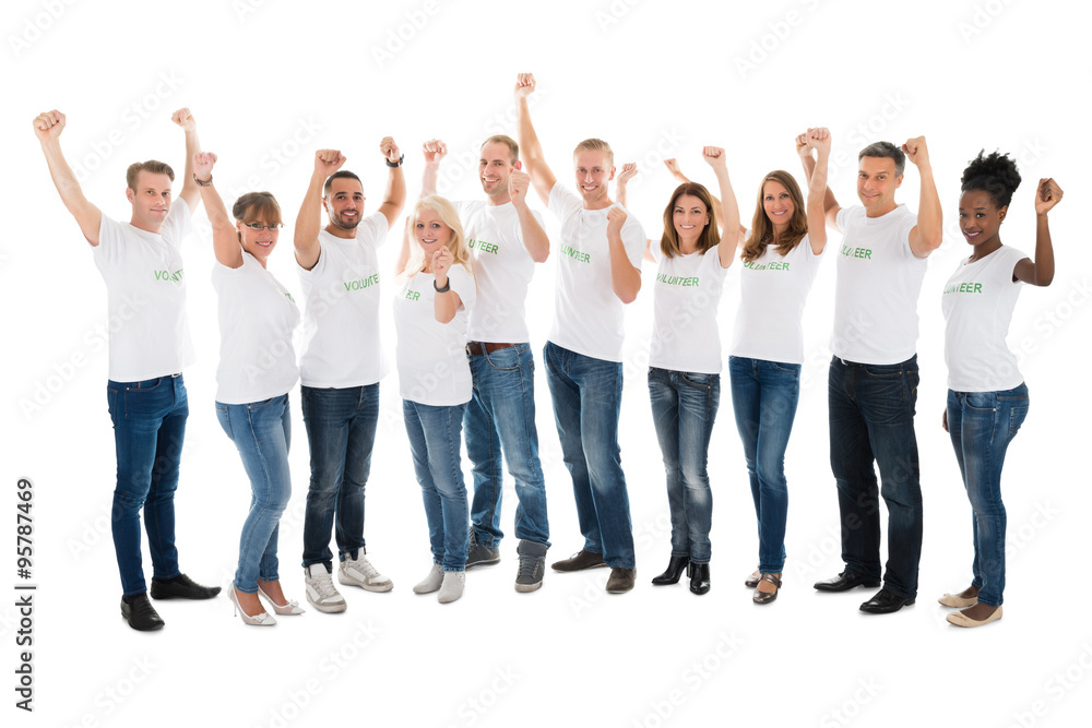 Confident Volunteers With Arms Raised Standing In Row