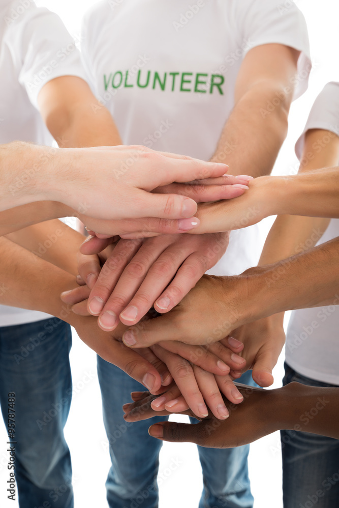 Midsection Of Multiethnic Volunteers Piling Hands Midsection Of Multiethnic Volunteers Piling Hands