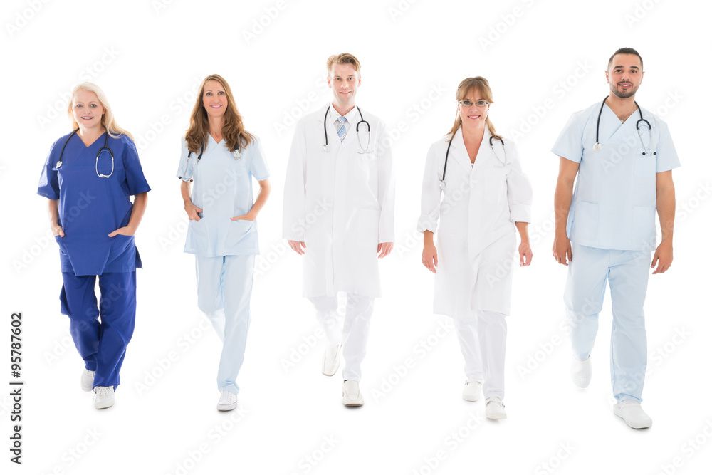 Portrait Of Confident Medical Team Walking In Row Portrait Of Confident Medical Team Walking In Row