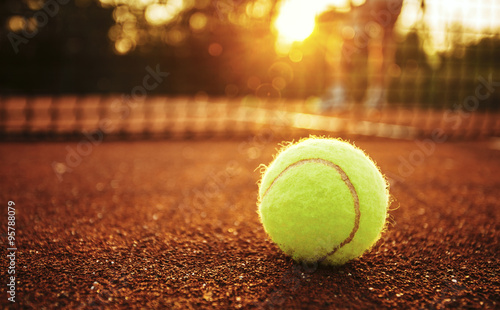 Tennis ball/Close up of tennis ball on clay court. © likoper