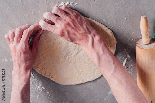 Man making dough for pizza