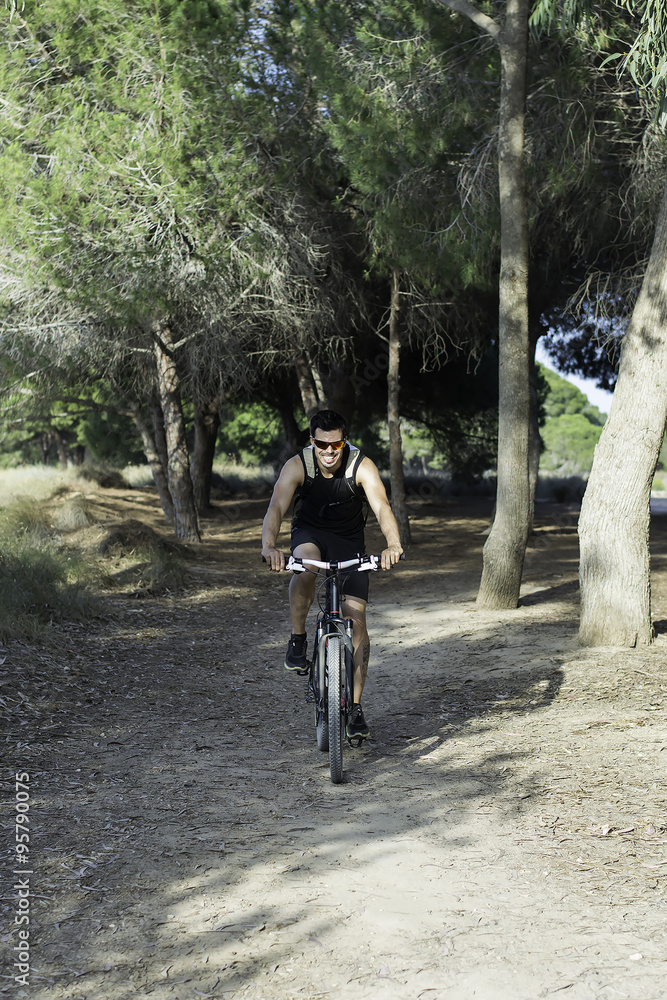 Young man riding a mountain bike outdoor. Young man riding a mountain bike outdoor.