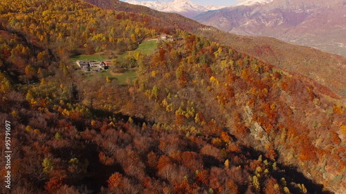 Flying with drone over woodlans in a beautiful sunny day of autumn photo