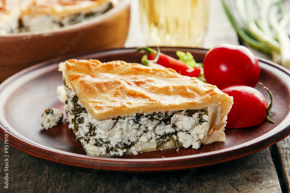 homemade pie with feta cheese and spinach in a clay bowl homemade pie with feta cheese and spinach in a clay bowl