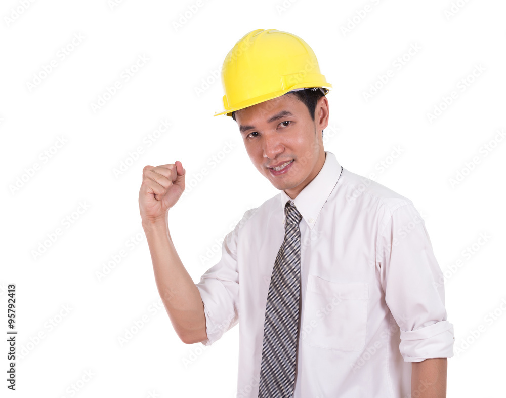 Happy young engineer celebrating with arm raised, concept of suc Happy young engineer celebrating with arm raised, concept of suc