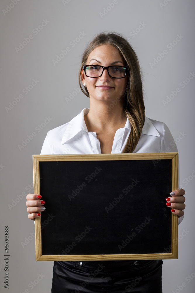 Young businesswoman holding blank chalkboard Young businesswoman holding blank chalkboard