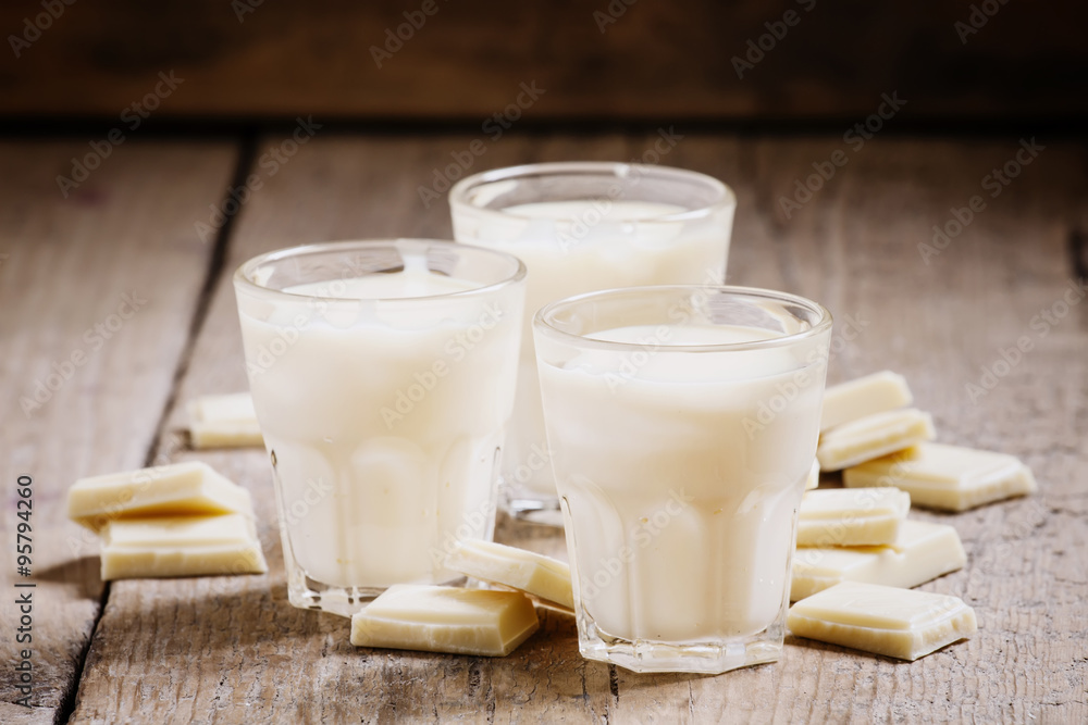 White chocolate mousse in small cups and pieces of chocolate on White chocolate mousse in small cups and pieces of chocolate on