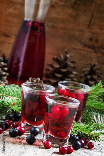 Winter drink with cranberry, cowberry and black chokeberry on th