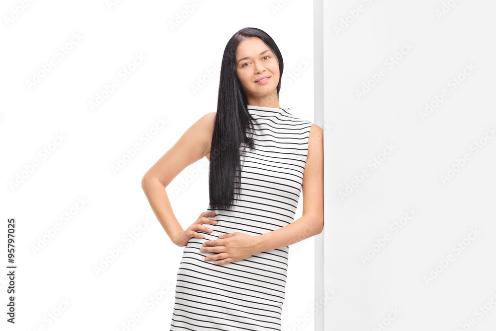 Woman posing in a white dress with black stipes Woman posing in a white dress with black stipes