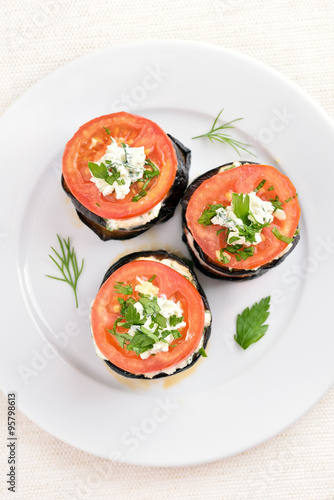 Baked slices of eggplant with tomato and curd cheese