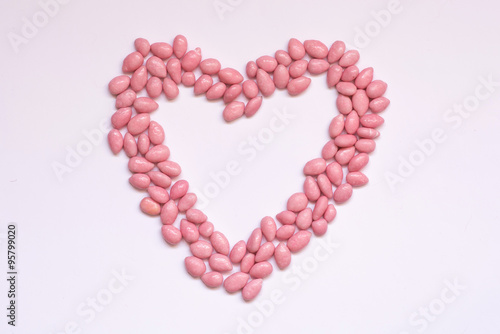 Pink dragees in heart shape