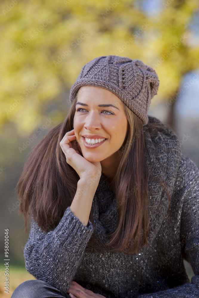 Autumn in the park, Young smiling woman relaxing in nature Autumn in the park, Young smiling woman relaxing in nature