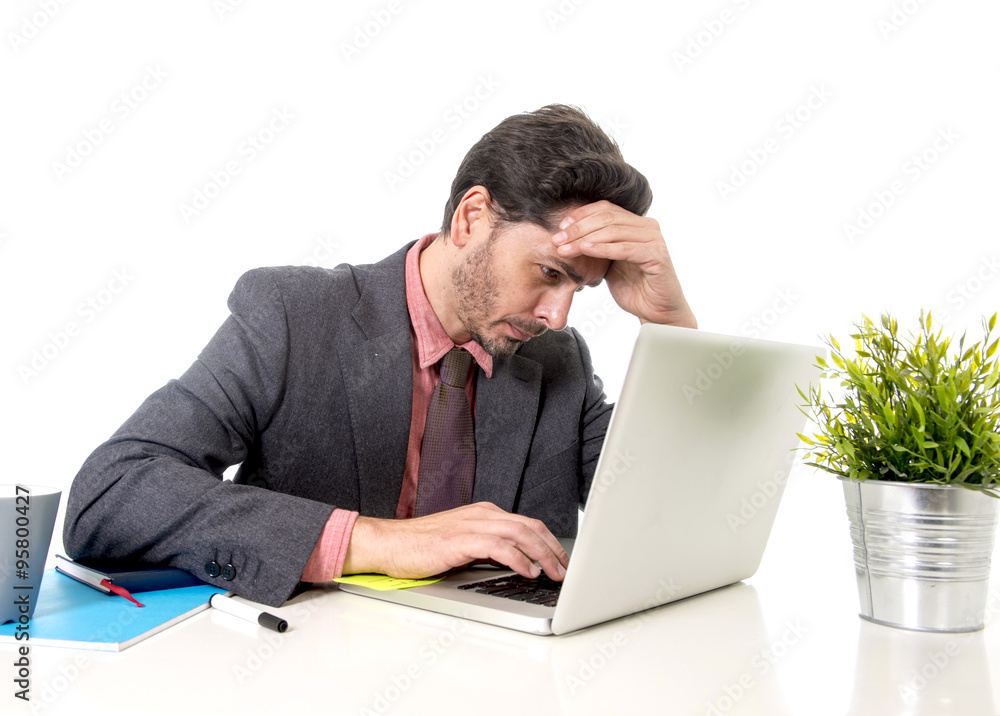 businessman in suit and tie sitting at office desk working on c businessman in suit and tie sitting at office desk working on c