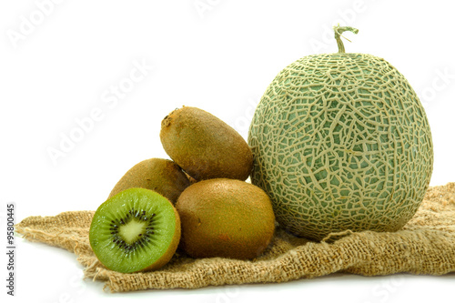 Netted melon and kiwi on white background