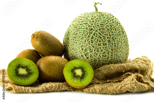 Netted melon and kiwi on white background
