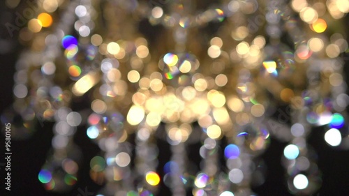 Crystal chandelier on black background. Crystals sway and sparkle.