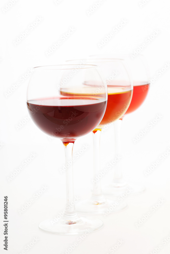 Wine bar, three glasses of wine unusual perspective on white background. Wine bar, three glasses of wine unusual perspective on white background.