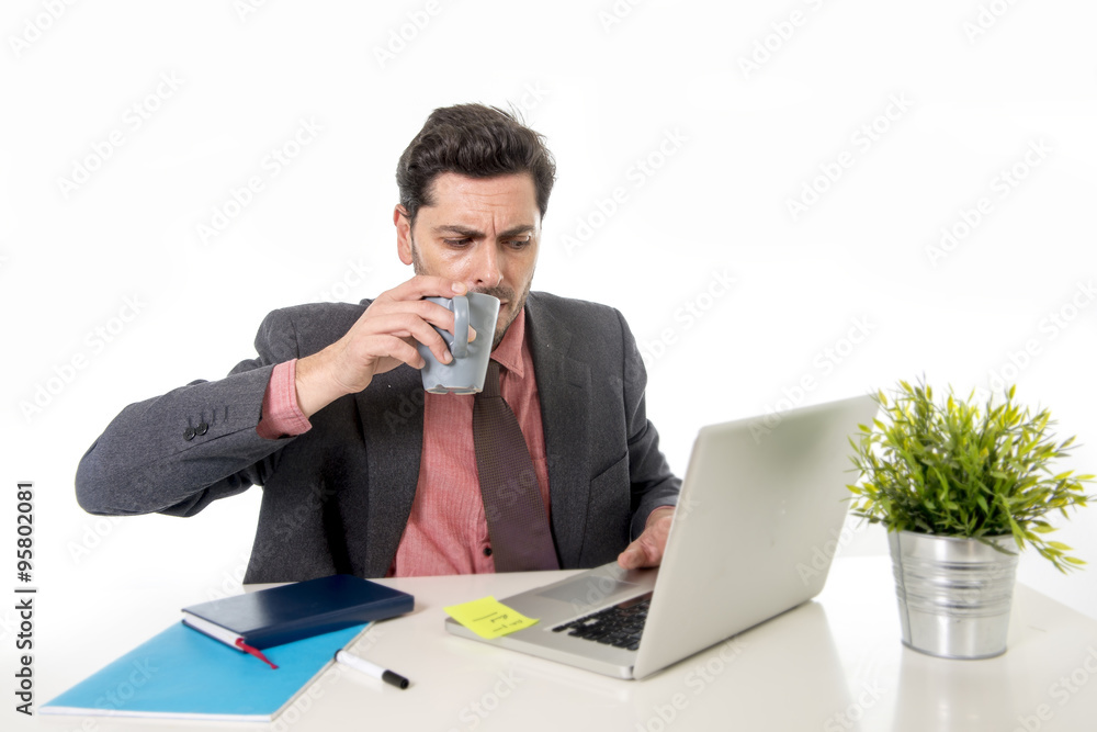 young attractive Latin businessman in suit and tie working at of young attractive Latin businessman in suit and tie working at of