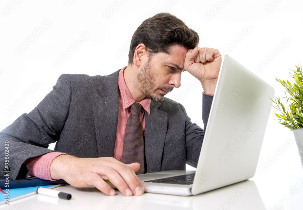 attractive businessman in suit and tie working in stress at offi attractive businessman in suit and tie working in stress at offi