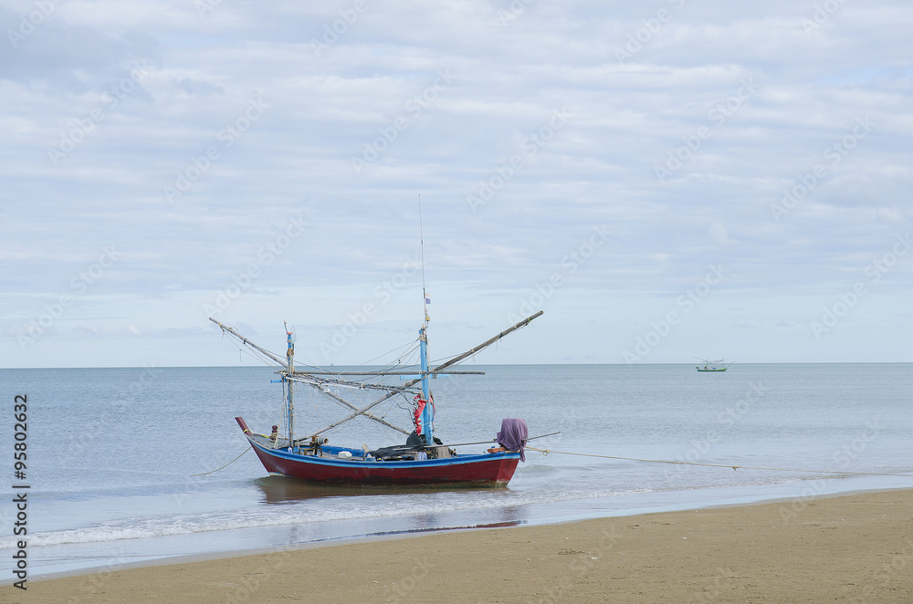 Beautiful ocean beach an fishing boat