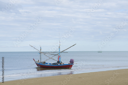 Beautiful ocean beach an fishing boat