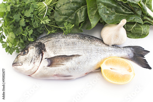 Fish dorade with swiss chard, parsley, garlic and lemon photo